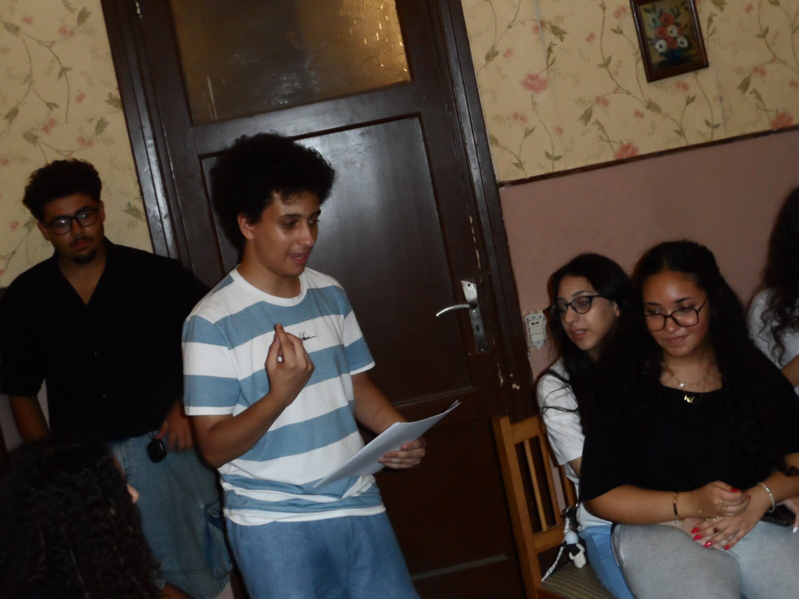 A member presenting clues to the group during the murder mystery