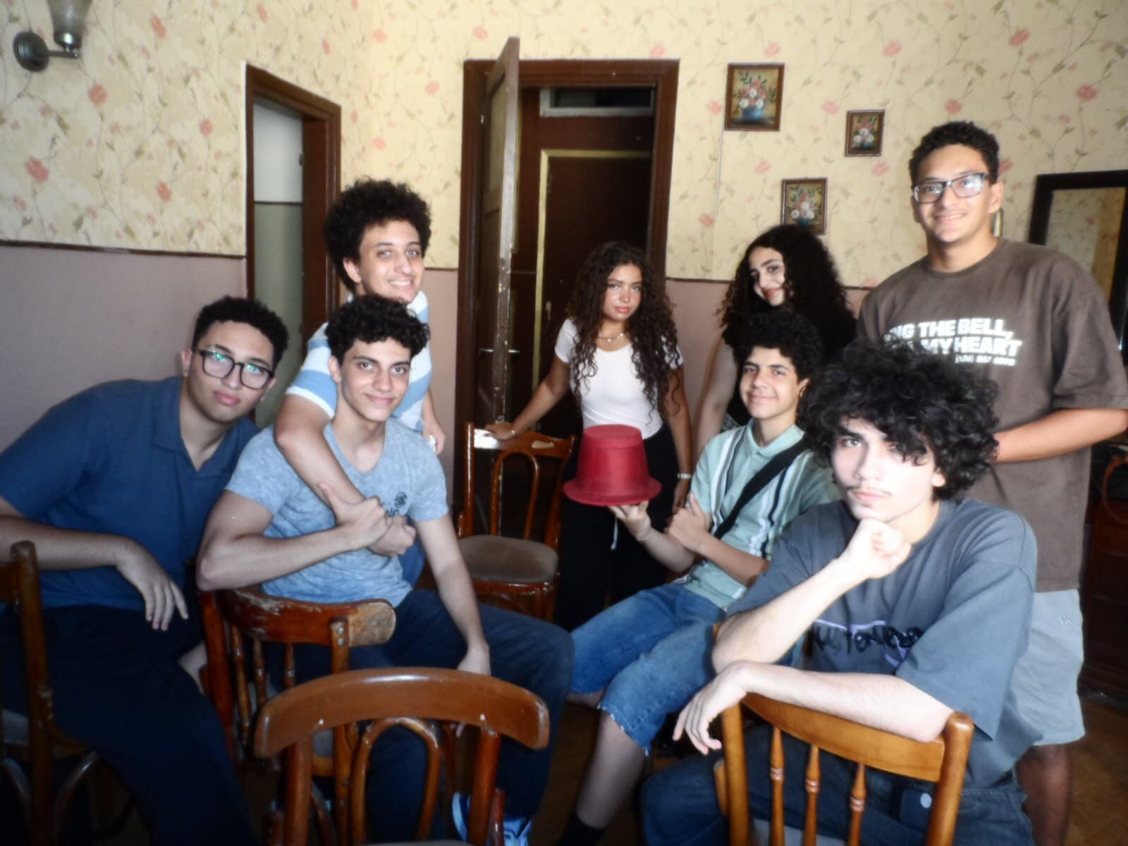 Interact Agora group portrait from the murder mystery event, with a red top hat